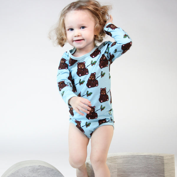 Girl wearing Smafolk organic Long sleeved bodysuit- bear cub, stratosphere blue