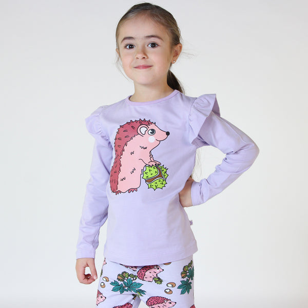 Girl wearing Smafolk organic Long sleeved frill t-shirt- hedgehog, orchid petal