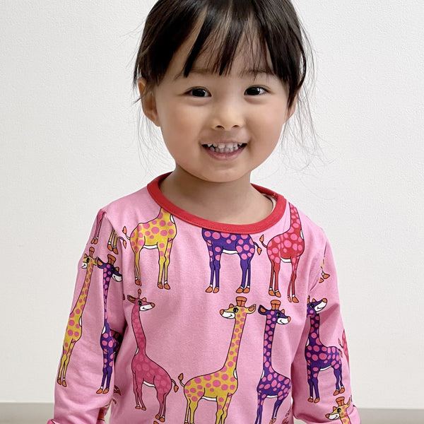 Girl wearing Smafolk organic Giraffes t-shirt, sea pink