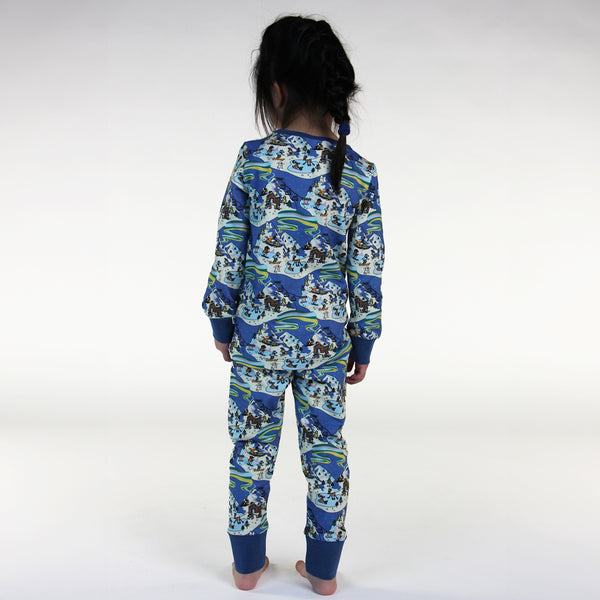 Girl wearing Smafolk organic Pajamas- winter landscape, back