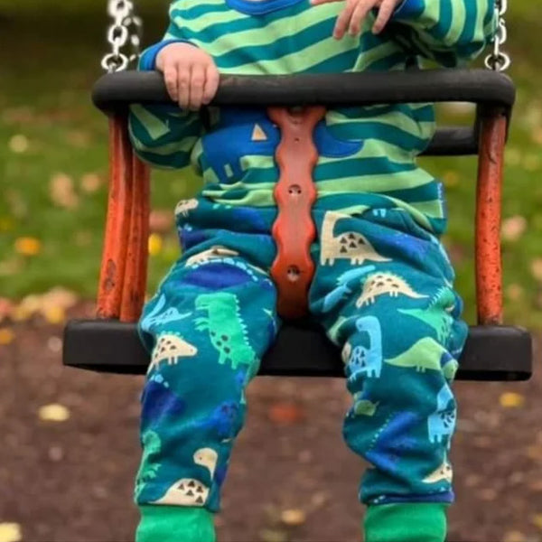 Boy wearing Toby Tiger organic Joggers- dinosaur print