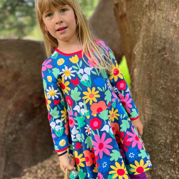 Girl wearing Toby Tiger organic Skater dress- bold floral