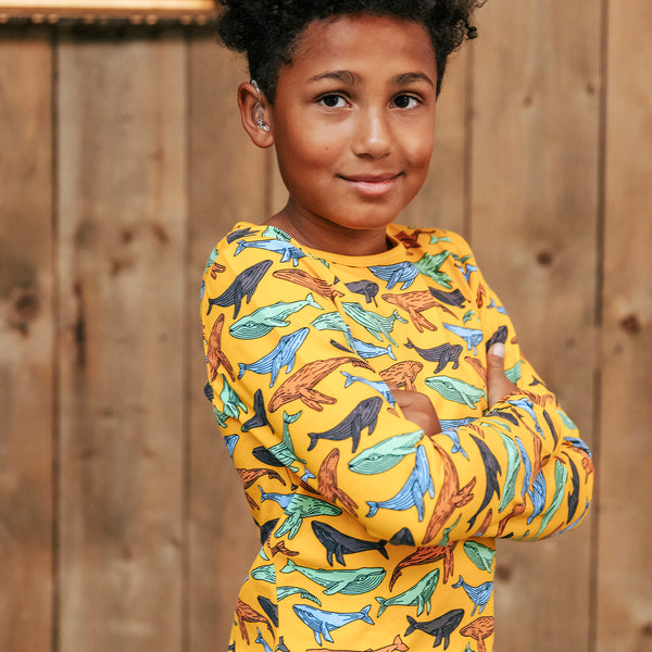 Boy wearing Villervalla organic Long sleeve top- whales, turmeric