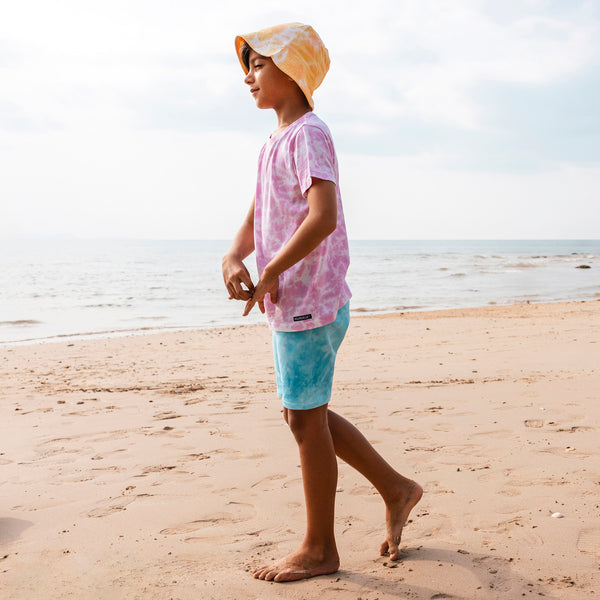 Boy wearing Villervalla organic Shorts- lake/pool tie dye