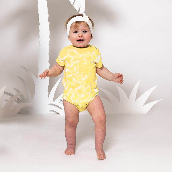 Baby wearing Villervalla organic Bodysuit- lemon tie dye