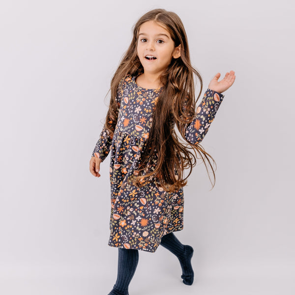 Girl wearing Walkiddy organic Long sleeve dress- fancy flowers