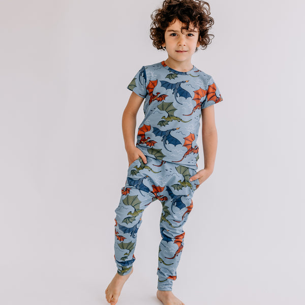Boy wearing Walkiddy organic Joggers- colorful dragons