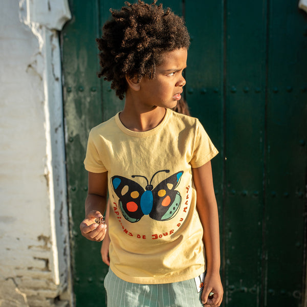 Boy wearing NAADA organic Butterflies of Morocco t-shirt