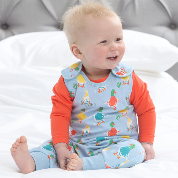 Baby wearing Piccalilly organic Dungarees- duck days
