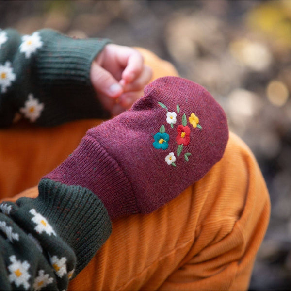 Girl wearing Little Green Radicals organic Knitted mittens- hazelnut embroidered