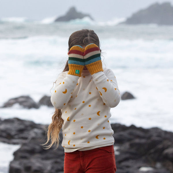 Girl wearing Little Green Radicals Organic Knitted mittens- rainbow stripe