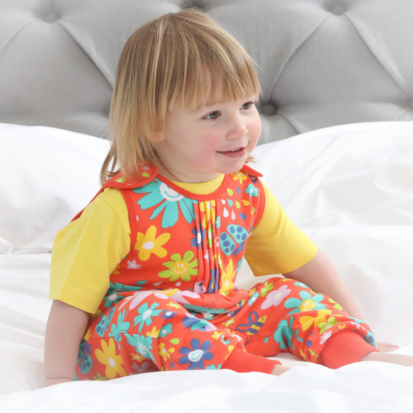 Baby wearing Piccalilly organic Dungarees- flower power