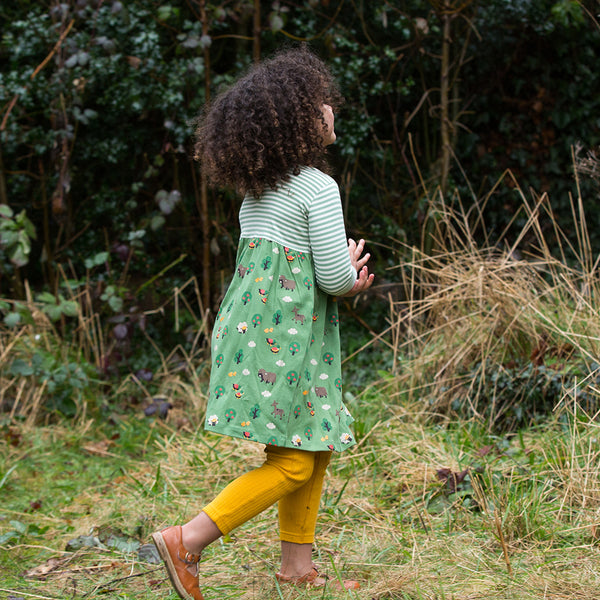 Girl wearing Little Green Radicals organic Animal friends easy peasy dress