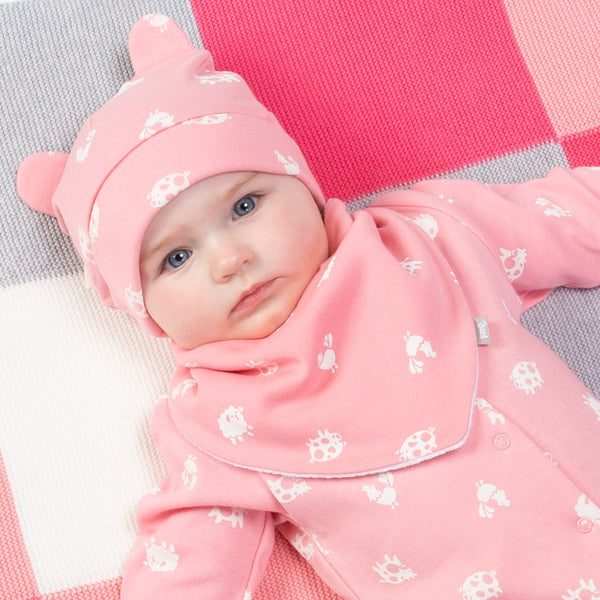 Baby wearing Kite pink polka farm bib
