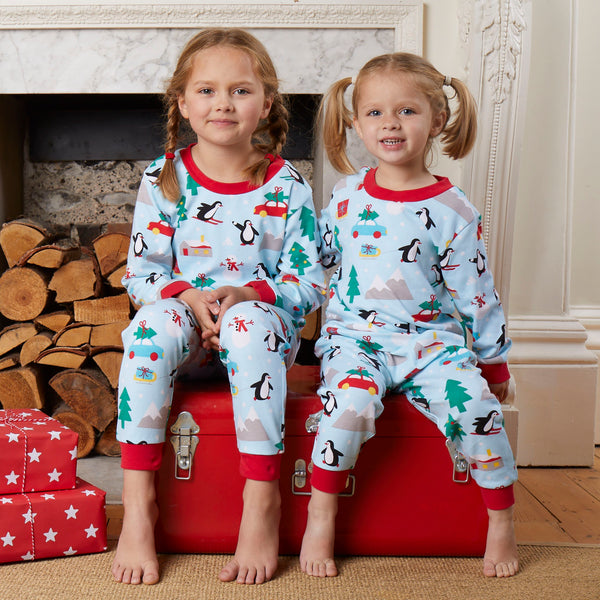 Girls wearing Toby Tiger Penguin's Christmas print pajamas