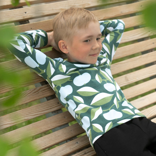 Boy wearing PaaPii organic Uljas long sleeve shirt- light blue & green apple joy