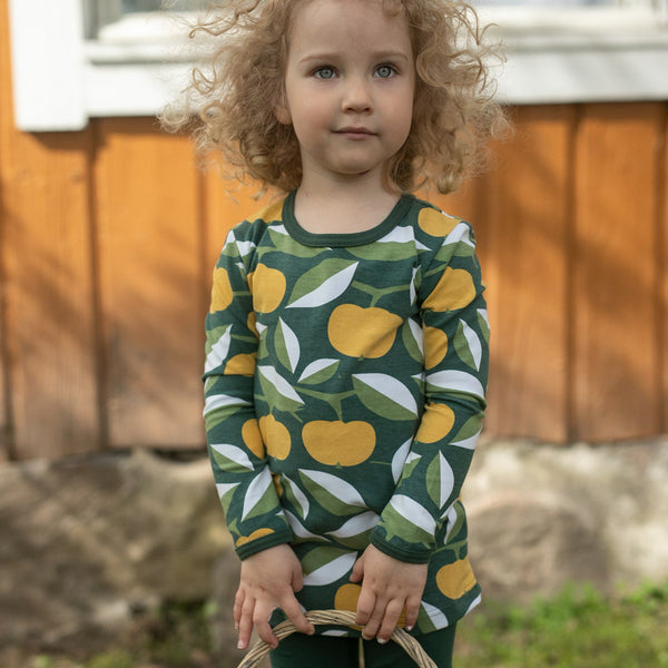 Girl wearing PaaPii organic Vieno long sleeve tunic- ochre & green apply joy