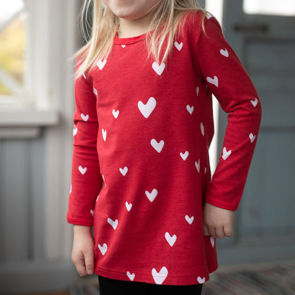 Girl wearing PaaPii organic Vieno long sleeve tunic- red hearts
