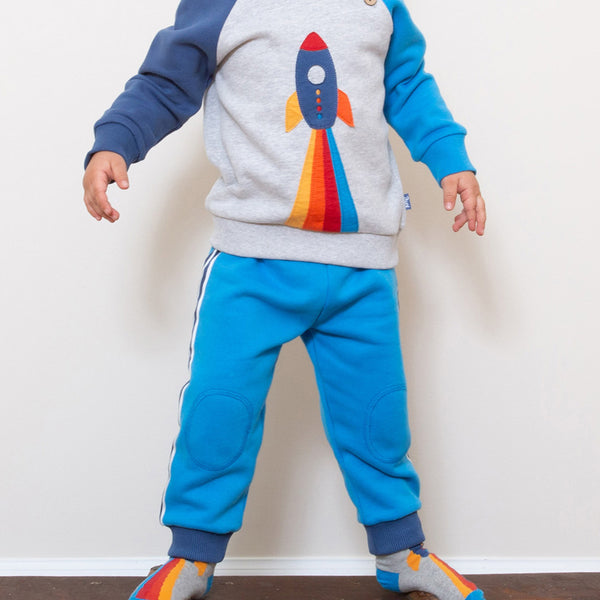 Boy wearing Kite Clothing organic Blue side stripe joggers