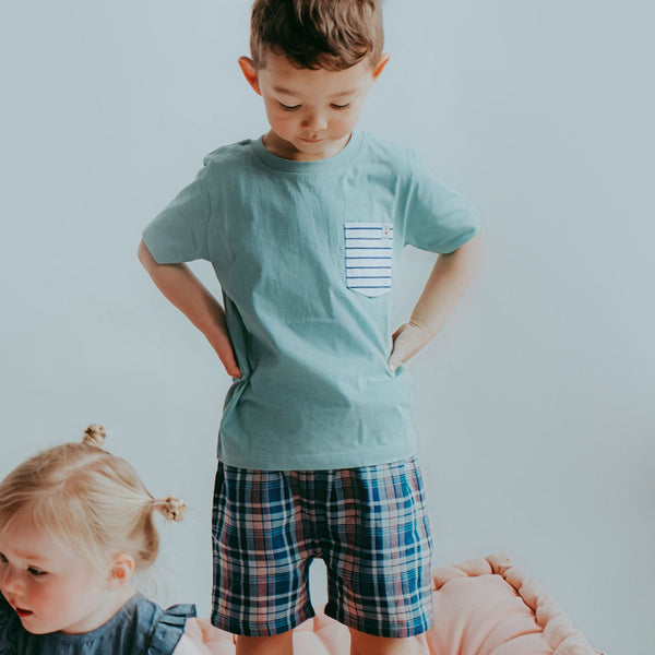 Boy wearing Lilly + Sid Check reversible shorts