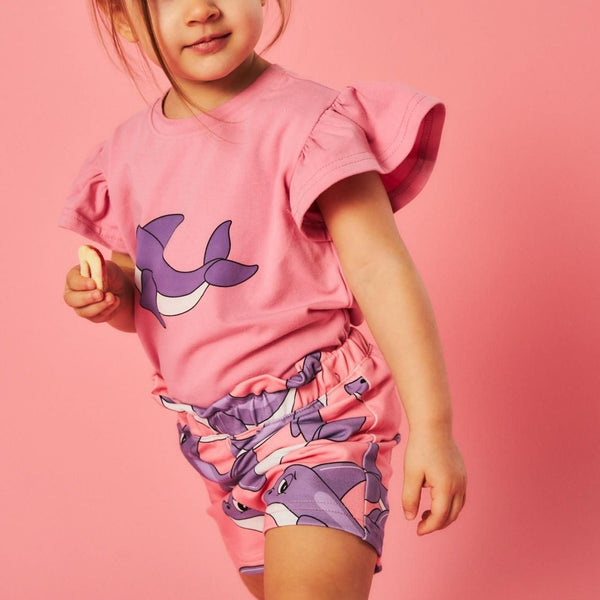 Girl wearing Dear Sophie organic Paperbag shorts- dolphin pink