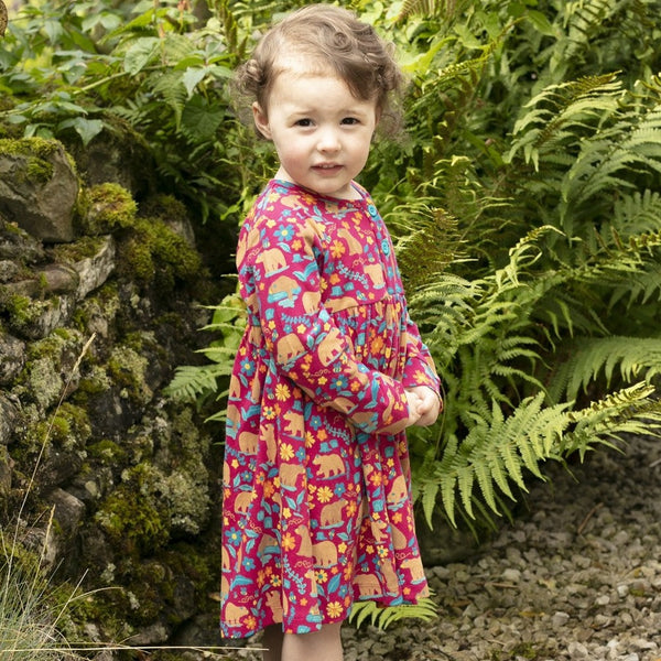 Girl wearing Piccalilly organic Button dress- honey bear