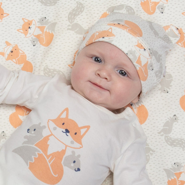 Baby wearing kite fox and squirrel hat