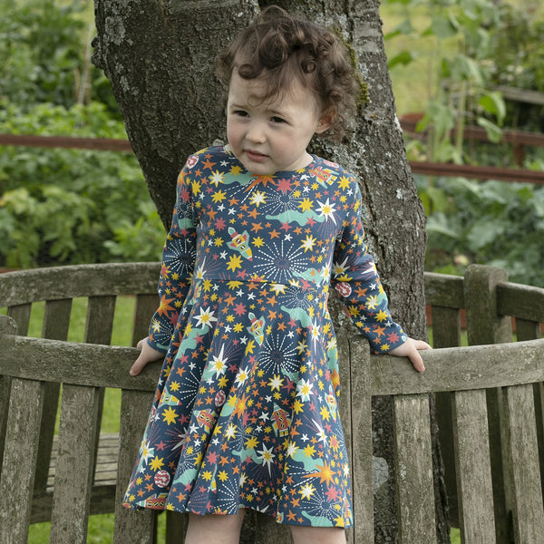 Girl wearing Piccalilly organic Skater dress- galaxy