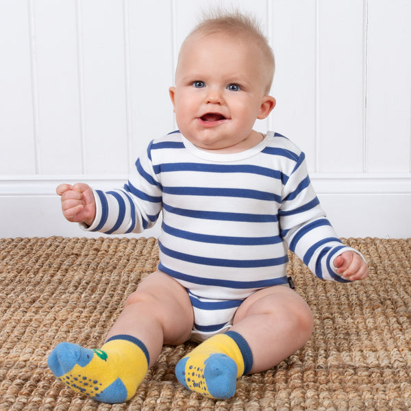 Baby wearing Kite's hippo grippy socks