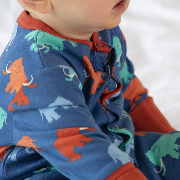 Baby wearing Piccalilly romper- mammoth