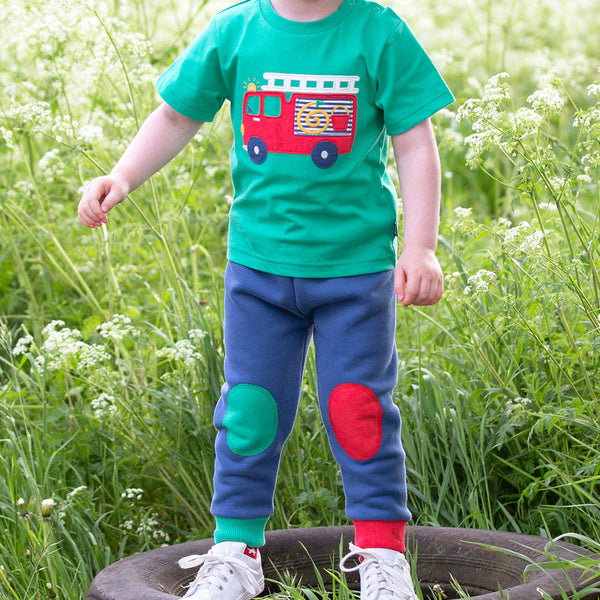 Boy wearing Kite Clothing organic Joggers- red & green knee patch
