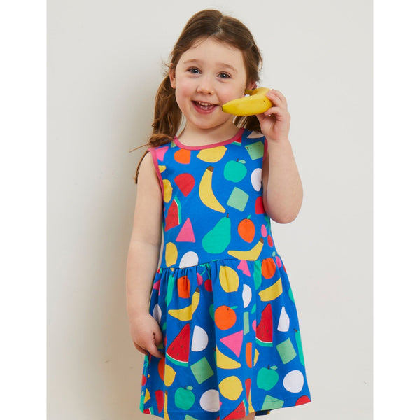 Girl wearing Toby Tiger organic Fruit print summer dress