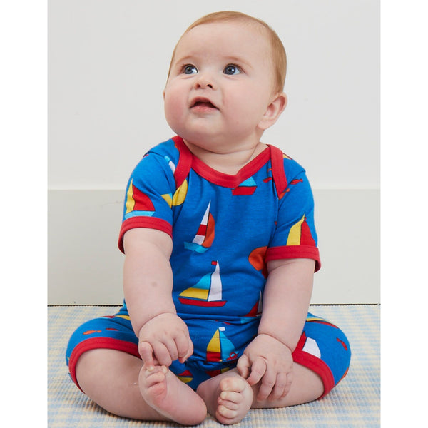 Baby wearing Toby Tiger organic Sailboat print short romper