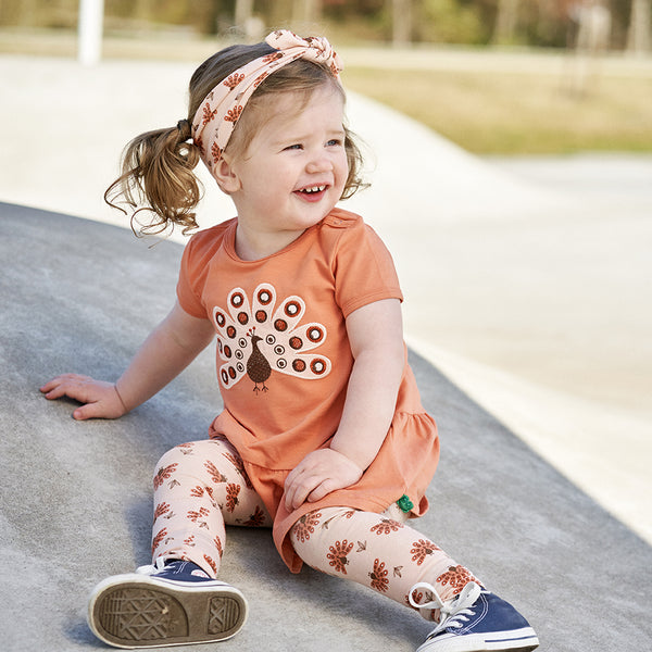 Girl wearing Fred's World Peacock leggings