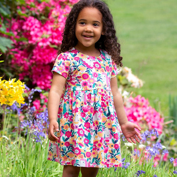 Girl wearing Kite Clothing organic Peek-a-pony dress