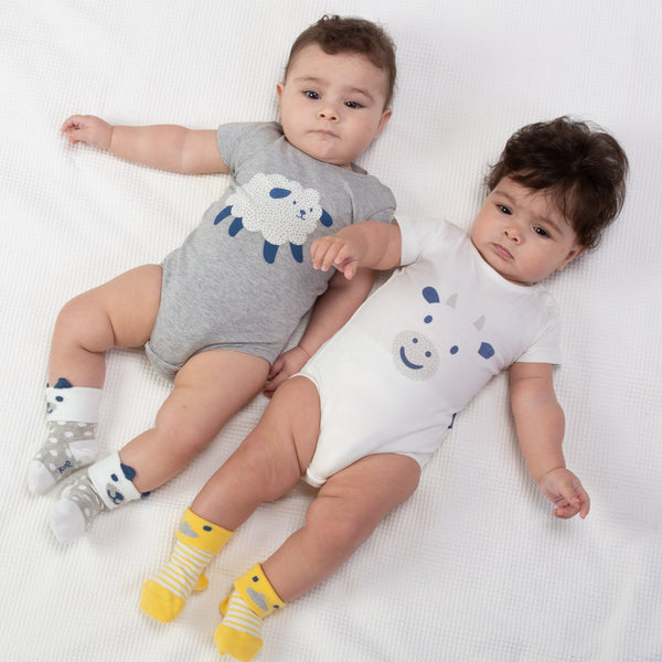 Babies wearing Kite pup and duck socks