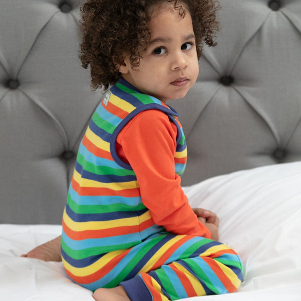 Baby wearing Piccalilly Dungarees- rainbow stripe
