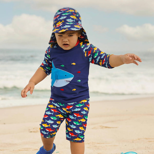 Baby wearing JoJo Maman Bebe Shark 2-piece sun suit