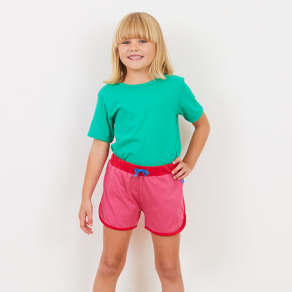 Girl wearing Toby Tiger pink running shorts