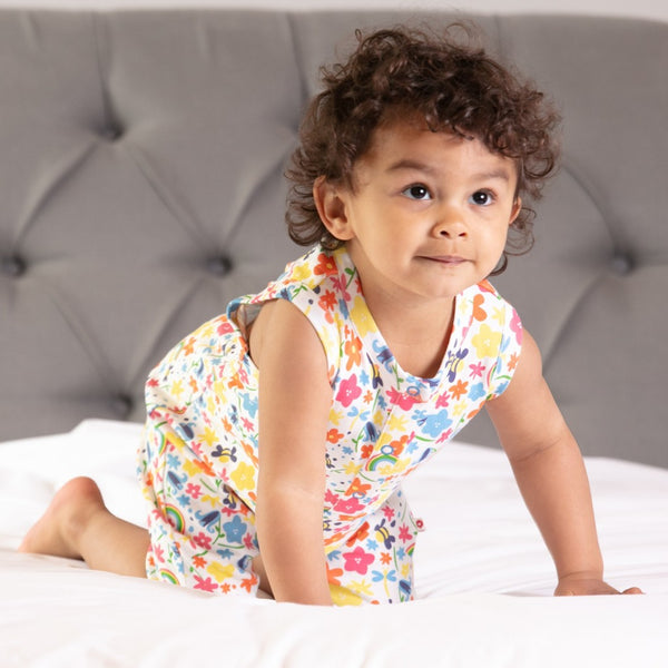 Baby wearing Piccalilly shortie romper- rainbow meadow