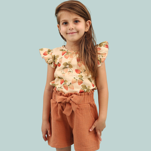 Girl wearing Walkiddy organic Ruffle sleeve shirt- strawberry garden