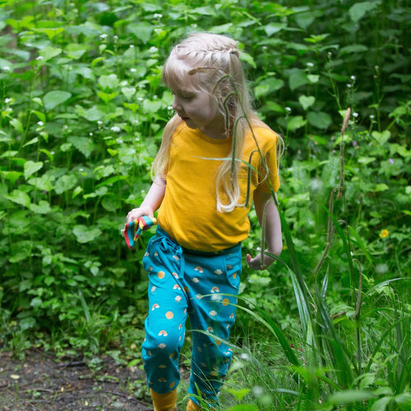 Girl wearing Little Green Radicals organic Sunny days joggers
