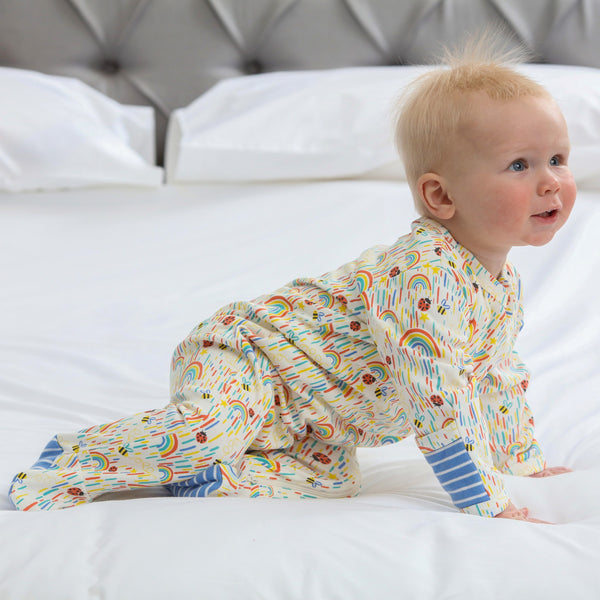 Baby wearing Piccalilly organic Footed pajamas- sun shower
