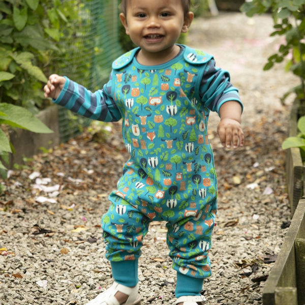 Baby wearing Piccalilly organic overalls- tree tops