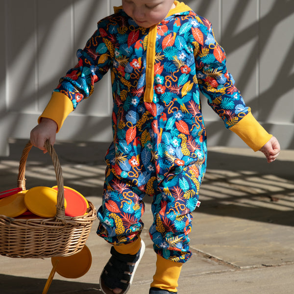 Boy wearing Piccalilly organic Hooded playsuit- tropic