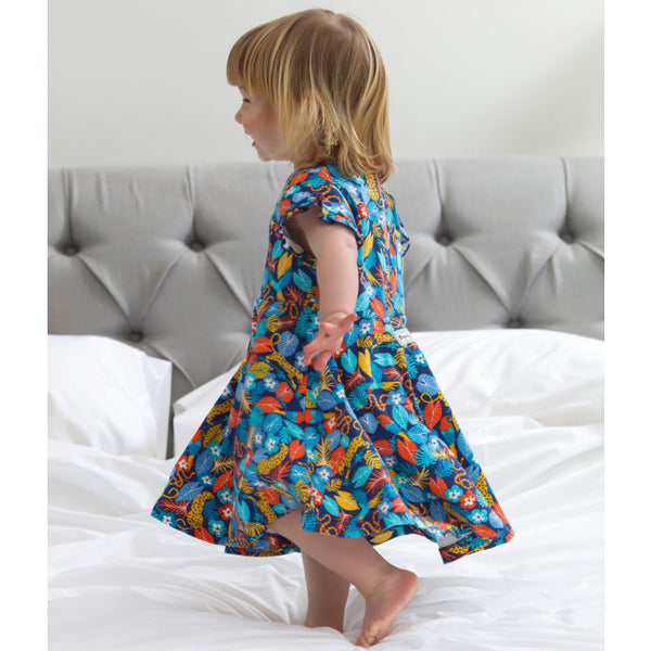 Girl wearing Piccalilly organic Skater dress- tropic