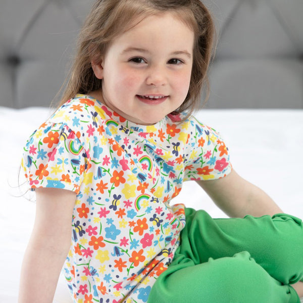Girl wearing Piccalilly all over print rainbow meadow t-shirt