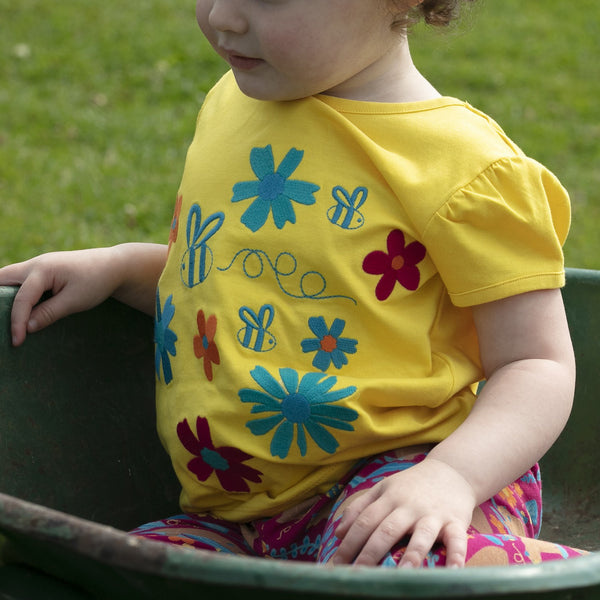 Girl wearing Piccalilly organic Short sleeve top- flowers
