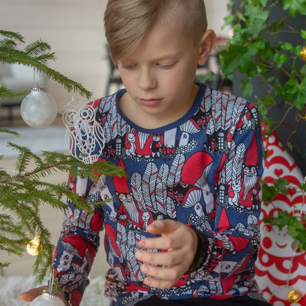 Boy wearing Uljas long sleeve shirt- Christmas forest